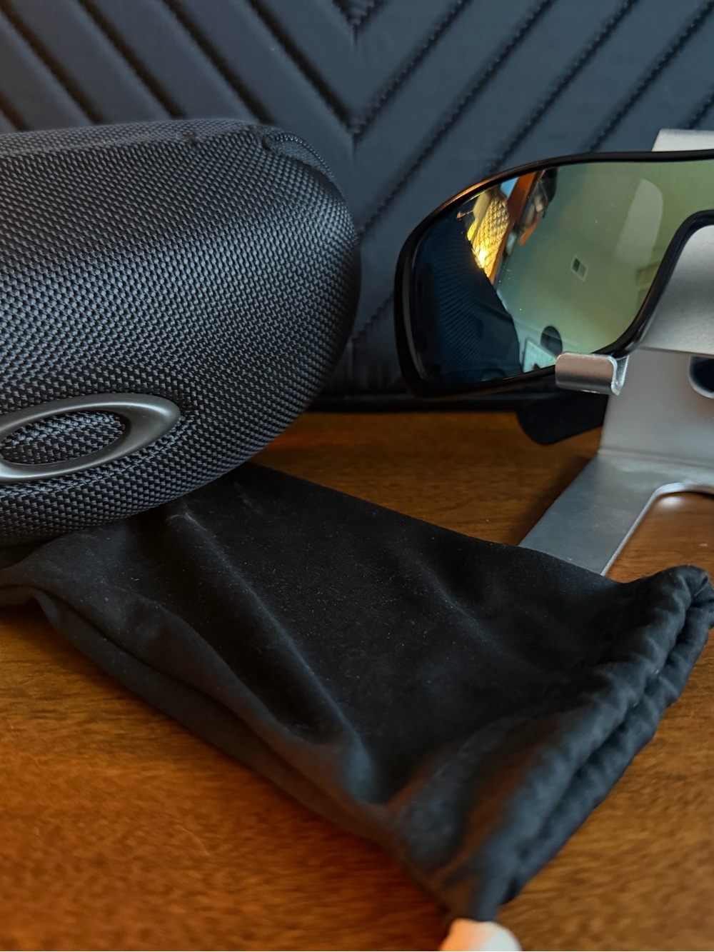 Oakley Black Frame Sunglasses with Blue-Green Mirrored Lenses
Antix